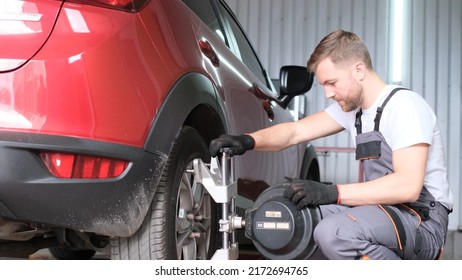 The Car Mechanic Adjusts The Car Control System. Car Service. Diagnosis Of A New Car