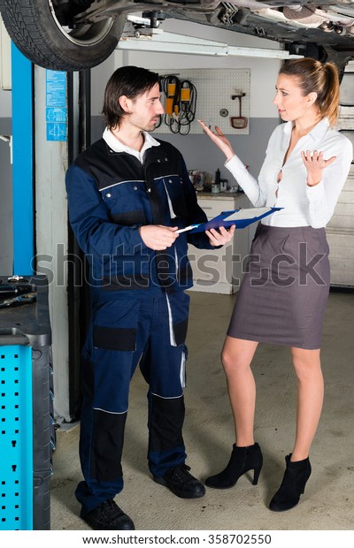 Car mechanic with\
angry female customer