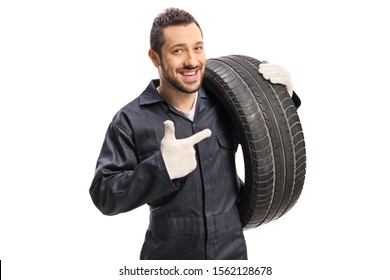 Car mechanic carrying a tire and pointing isolated on white background - Powered by Shutterstock