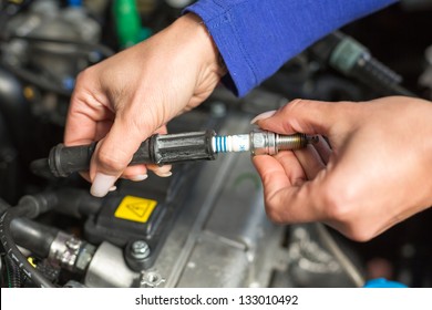 A Car Mechanic Changing Spark Plugs