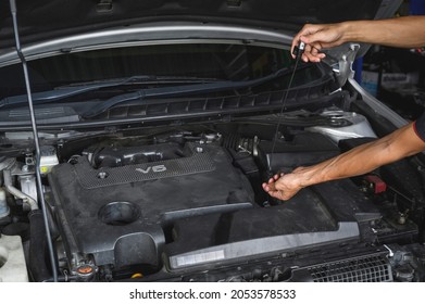 Car Mechanic Checking CVT Transmission Fluid Level.