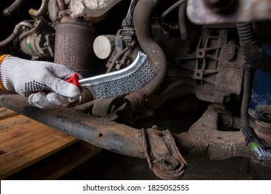 A Car Mechanic Cleans And Maintains The Engine Chassis Of An Old Car Against Corrosion And Protects It With A Preparation