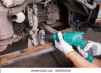 A Car Mechanic Cleans And Maintains The Engine Chassis Of An Old Car Against Corrosion And Protects It With A Preparation