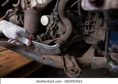 A Car Mechanic Cleans And Maintains The Engine Chassis Of An Old Car Against Corrosion And Protects It With A Preparation