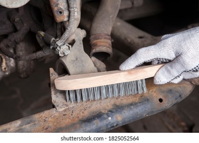 A Car Mechanic Cleans And Maintains The Engine Chassis Of An Old Car Against Corrosion And Protects It With A Preparation