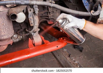 A Car Mechanic Cleans And Maintains The Engine Chassis Of An Old Car Against Corrosion And Protects It With A Preparation