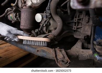 A Car Mechanic Cleans And Maintains The Engine Chassis Of An Old Car Against Corrosion And Protects It With A Preparation