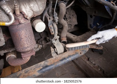 A Car Mechanic Cleans And Maintains The Engine Chassis Of An Old Car Against Corrosion And Protects It With A Preparation