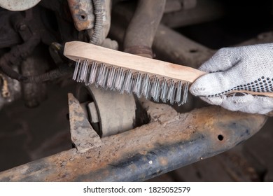 A Car Mechanic Cleans And Maintains The Engine Chassis Of An Old Car Against Corrosion And Protects It With A Preparation