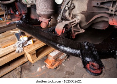 A Car Mechanic Cleans And Maintains The Engine Chassis Of An Old Car Against Corrosion And Protects It With A Preparation