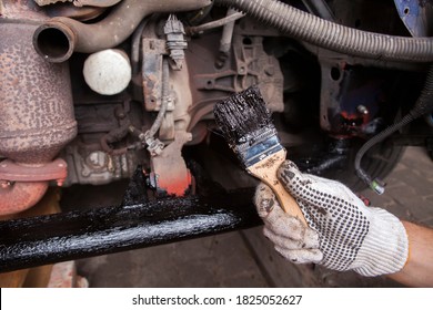 A Car Mechanic Cleans And Maintains The Engine Chassis Of An Old Car Against Corrosion And Protects It With A Preparation