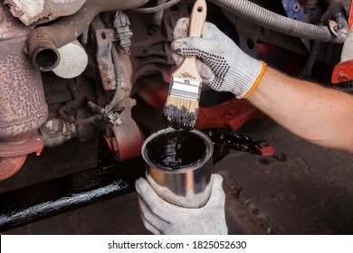 A Car Mechanic Cleans And Maintains The Engine Chassis Of An Old Car Against Corrosion And Protects It With A Preparation