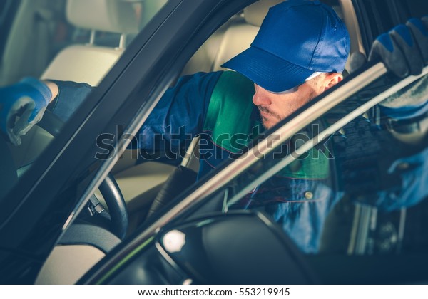 Car Mechanic Fixing Vehicle While\
Seating Inside the Car. Professional Car\
Maintenance.
