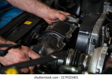 Car Mechanic Hands Replacing Engine Throttle Body. Mechanics Workshop.