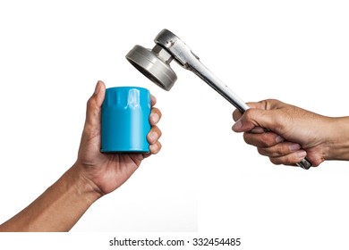 Car mechanic hold an oil filter and a ratchet wrench in his hand isolated on white background