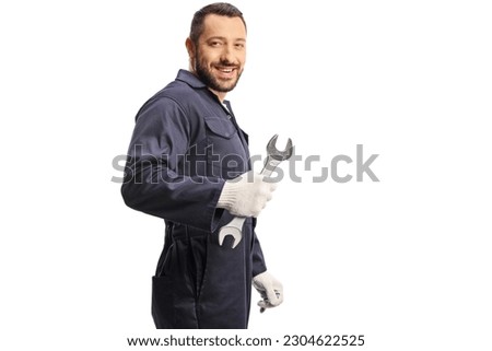 Car mechanic holding a wrench and looking over shoulder isolated on white background