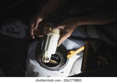 Car Mechanic Installing An Electric Fuel Pump Module. 