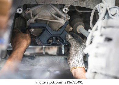 Car mechanic installing engine mount. - Shutterstock ID 2136723491