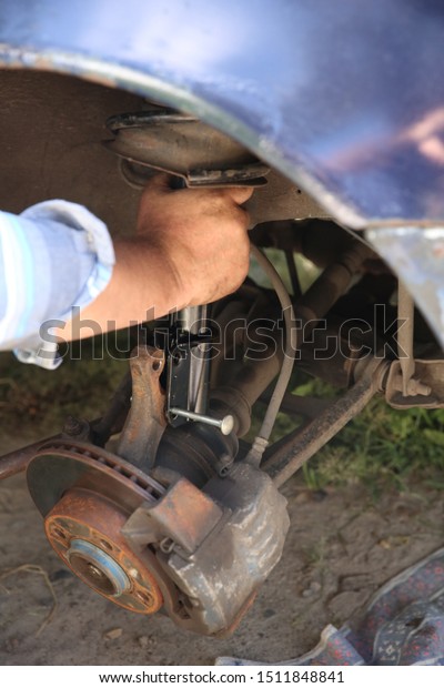 Car mechanic makes car\
repair\
