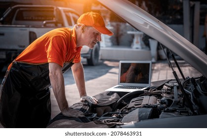 Car Mechanic Open Hood To Repair And Check Car Problem System By Laptop For Maintenance And Fixed In Garage.