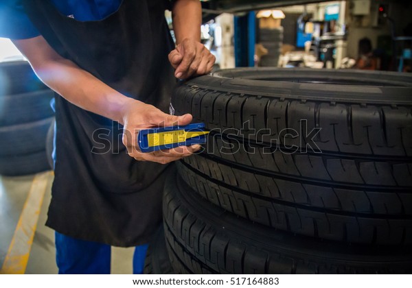 Car mechanic, Professional car mechanic\
changing car wheel in auto repair\
service.