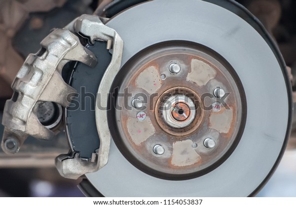 Car mechanic Repairing\
brakes on car