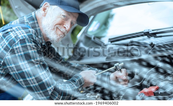 Car\
mechanic repairing a car engine; light\
effect