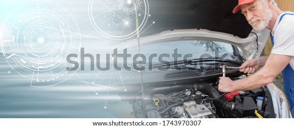 Car\
mechanic repairing a car engine; panoramic\
banner