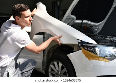 car mechanic repairs car bodywork of a vehicle after a traffic accident 