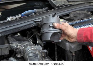 Car Mechanic Replacing Fuel Filter At Modern Diesel Engine