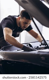 Car mechanic at car service checking up the car