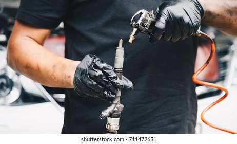 Car Mechanic Or Serviceman Disassembled Car Dirty Engine For Cleaning Fuel Injection And Air Flow System Engine Parts For Fix And Repair Problem At Car Garage Or Repair Shop