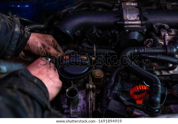 Car\
mechanic servicing car engine in car service\
closeup