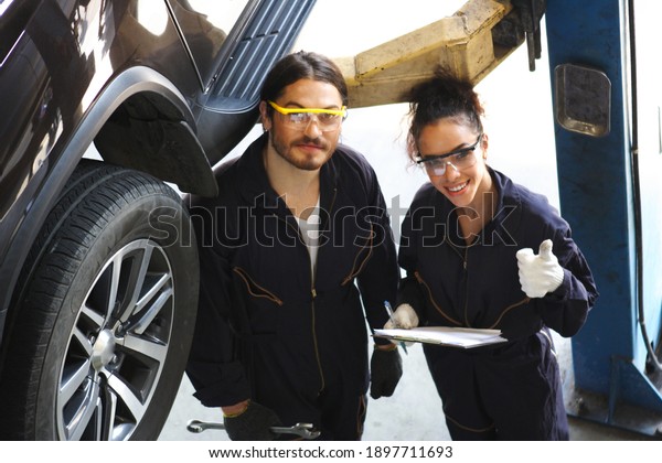 car mechanic use\
notebook computers to check engine and service maintenance of\
industrial to engine repair, for transport automobile automotive ,\
top view image 