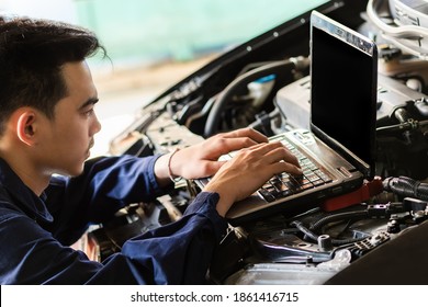 Car Mechanic Using Computer To Connect To The Engine Engine Tuning.
