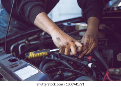 Car Mechanic using tools on engine and motor - Shutterstock ID 1800941791