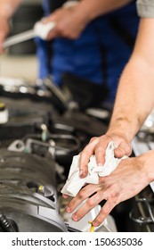 Car Mechanic Wiping His Dirty Hands With Cloth