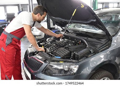 Car Mechanic Work Clothes Checks Engine Stock Photo 1749522464 ...