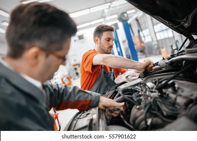 Car Mechanic Working At Automotive Service Center