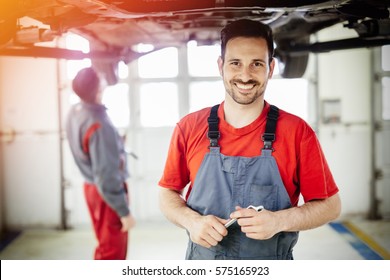 Car mechanic working at automotive service center