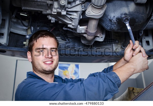 Car mechanic. Working on the car. Oil change.\
Car service.