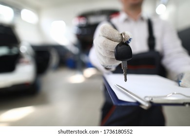 Car Mechanic In Workshop Extends Out From Car. Service Station Steering Check. Reliable Information About Purchased Car. Pay Damages To Injured Party. Comprehensive Car Repair And Maintenance