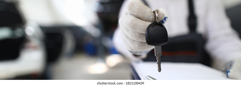 Car Mechanic In Workshop Extends Out From Car. Service Station Steering Check. Reliable Information About Purchased Car. Pay Damages To Injured Party. Comprehensive Car Repair And Maintenance