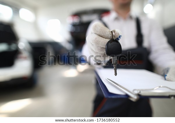 Car mechanic in workshop extends out from\
car. Service station steering check. Reliable information about\
purchased car. Pay damages to injured party. Comprehensive car\
repair and maintenance