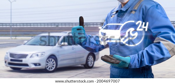 Car Mechanics hand holding 24 hours\
service icon, recovery vehicle, Repair, Maintenance, Technical\
Support, Professional auto service Center\
concept.