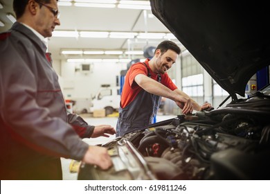 Car Mechanics Working On Car Maintenance