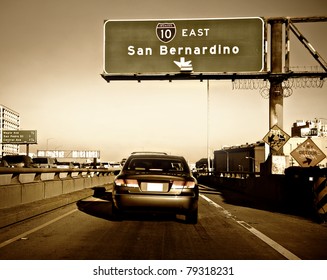 Car Merging Onto Packed Highway In Los Angeles During Rush Hour On A Hot Day.