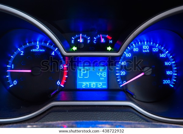 Car meter in blue light\
tone.