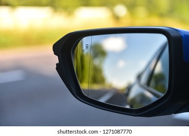 Car mirror with blind spot warning. The car with blind spot monitor which detects other vehicles on the side.