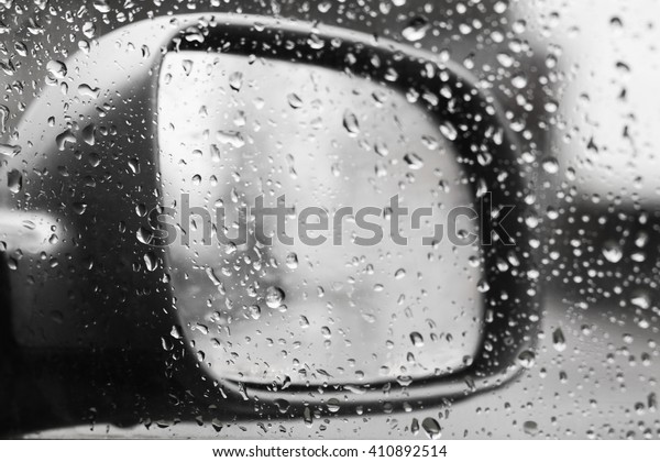 Car mirror, raining
outside